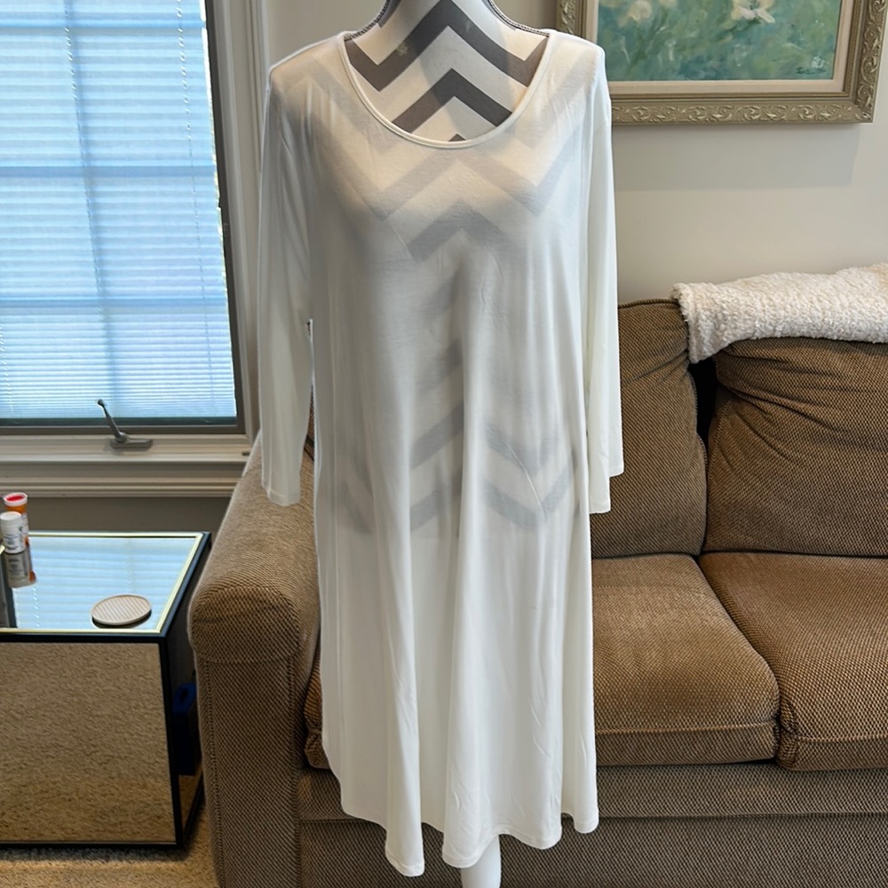 White dress to wear alone or with a jacket . Easy care. Little scoop neck .